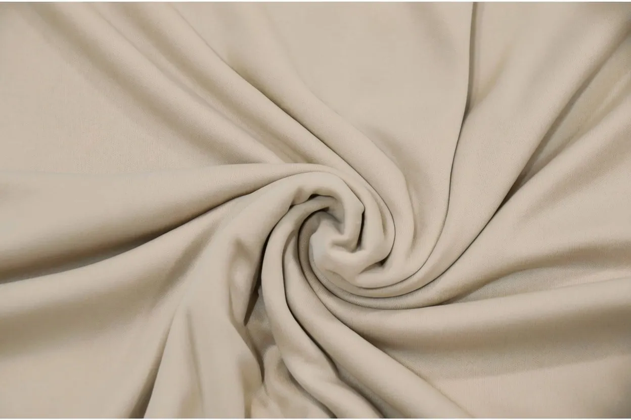 Interlock knit fabric in warm stone cotton with smooth dense surface, manufactured at Apex Corporation knitwear factory in Karachi Pakistan